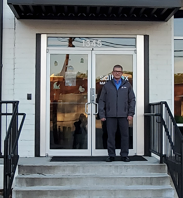 expert-compressed-air-and-pump-expert-standing-on-grey-steps-outside-of-Rogers-Machinery's-Atlanta-Georgia-Branch